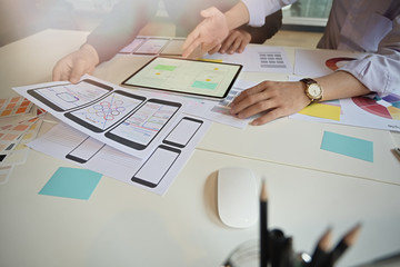 UX UI designer team using tablet designing wireframe web mobile phone layout