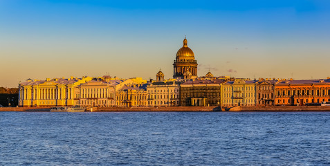 Sunset in Saint Petersburg over the Neva river with the view of the Palace Embankment and the Saint Isaac's Cathedral