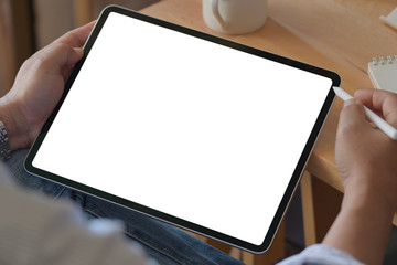 Fototapete - Young man using a tablet in office workspace