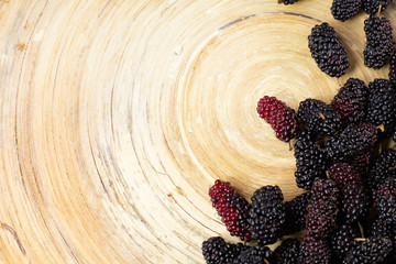 Wall Mural - The mulberry fruit in white bowl on wood table.