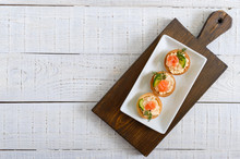 Tartlets With Cream Cheese And Salted Salmon On A White Plate. Tasty Light Snack For A Party. Finger Food. The Top View, Flat Lay.