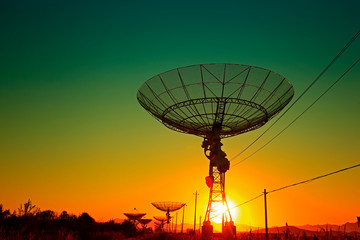 The silhouette of a radio telescope observatory