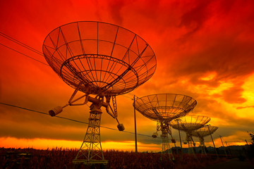 The silhouette of a radio telescope observatory