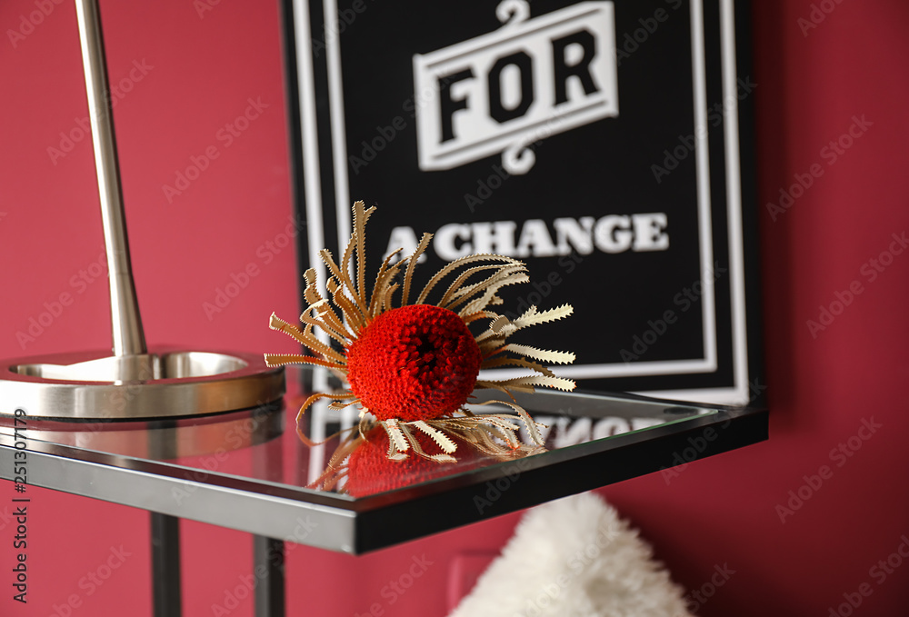 Tropical flower on glass table in interior of room