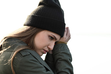 Wall Mural - Young depressed woman thinking about suicide outdoors