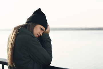 Wall Mural - Young depressed woman thinking about suicide on bridge