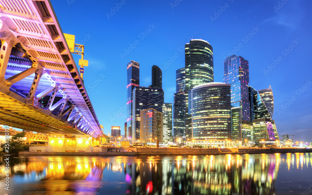 Skyscrapers of Moscow City business center and Moscow river in Moscow at night, Russia. Architecture and landmark of Moscow - obrazy, fototapety, plakaty 