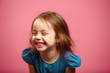 © Ilshat - Portrait of child girl with a smile looking to the side on pink isolated background.