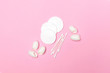 Cotton pads and cotton swabs on pink background