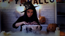 Beautiful Witch Performing Mysterious Magic Ritual, Cooking Potion In Cauldron