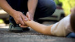 © motortion - Man holding hand of girl lying on road, unconscious victim of car accident, 911