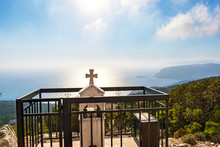 Roadside Memorial With Cross On Hill Over Aegean Sea Bay (Rhodes, Greece)