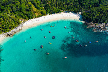 Wall Mural - View from above, aerial view of a beautiful tropical beach with white sand and turquoise clear water, longtail boats and people sunbathing, Freedom beach, Phuket, Thailand.