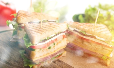 Wall Mural - Fresh tasty sandwiches on wooden background