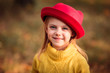 © Евгения Янцева - portrait of a little girl in a yellow sweater in the fall in a red hat