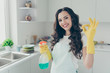 © deagreez - Close up photo beautiful busy nice duties she her lady house hold okey symbol washing supplies pulverize promo housemaid wear jeans denim casual t-shirt covered by cute apron bright light kitchen