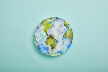 Wall Mural - top view of planet picture on turquoise background, earth day concept