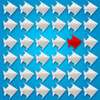 © pbombaert - Flying paper fish origami with a red one on blue background.