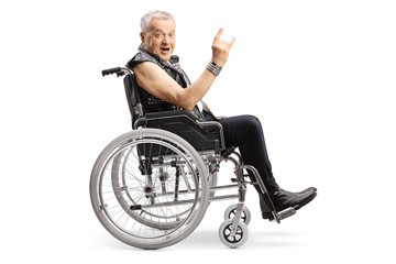 Sticker - Mature man in a wheelchair making a rock and roll hand sign and looking at the camera