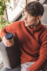 Sticker - overhead view of man in glasses holding paper cup in cafe