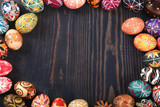 Fototapeta Nowy Jork - Easter decorated eggs on a wooden background.