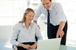 © potstock - corporate business training - businessman working with pretty woman on laptop in office