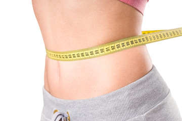 sport, fitness and diet concept, trained belly with measuring tape, health