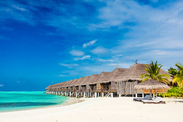 Wall Mural - Tropical beach with straw cabins on Maldives.