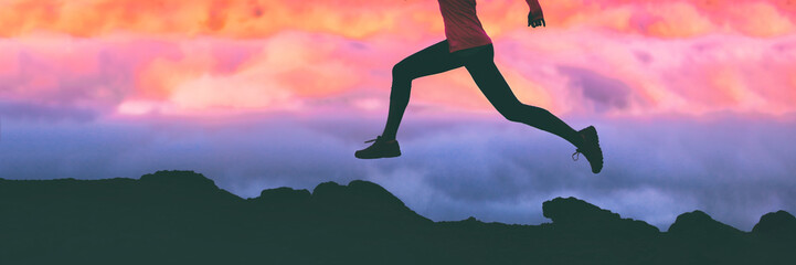 Wall Mural - Running legs silhouette of athlete runner woman trail running on mountain rocks against pink sunset sky background. Panoramic banner.