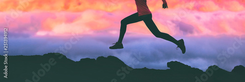 Cuadros en Lienzo Running legs silhouette of athlete runner woman trail running on mountain rocks against pink sunset sky background