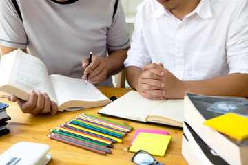 Students helps friend teaching and learning subject additional in library. Education concept.