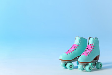 Wall Mural - pair of vintage roller skates on color background. space for text