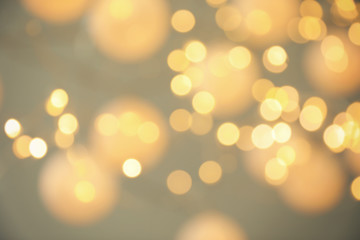 Blurred view of shiny gold lights. Bokeh effect