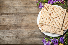 Flat Lay Composition Of Matzo And Flowers On Wooden Background, Space For Text. Passover (Pesach) Seder