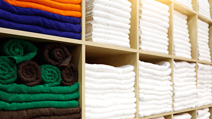 Leinwandbilder - Fresh White and colorful Hotel Towels Folded and Stacked on a Shelf