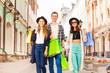 © Sergey Novikov - Three friends walking with shopping bags on street