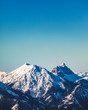 landscape of snow covered mountaintops with clear blue sky