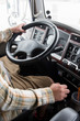 © Jamie Grill Photography/Tetra Images - Hands of truck driver operating semi-truck