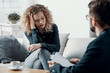 © Photographee.eu - Blonde overwhelmed businesswoman sitting on the couch in psychotherapist office