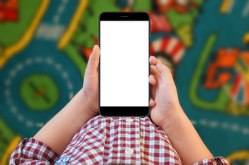 A little boy holding smartphone in hands on colorful background