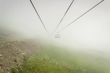 cableway in the mountains on foggy day. alpine landscape