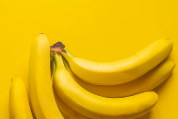 Wall Mural - a bunch of bananas on yellow background isolated copy space design mockup b