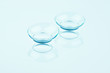 © revers_jr - Contact lenses on blue background.