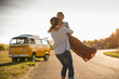 © Westend61 - Happy couple doing a road trip with a camper, embracing on the road