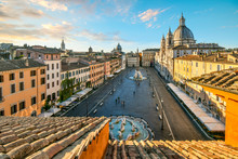Early Morning View From A Terrace Overlooking The Piazza Navona As The Sunlight Lights The Dome On The St. Agnes Cathedral In Rome, Italy