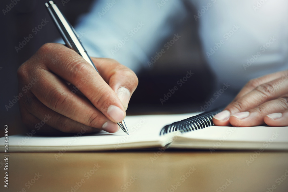 hand of woman holding pen with writing on notebook in office Stock ...