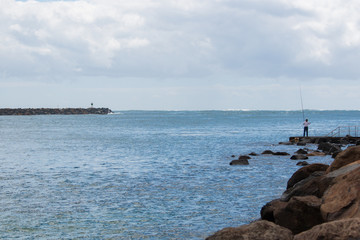 Wall Mural - sea and blue sky a men fishing Australia