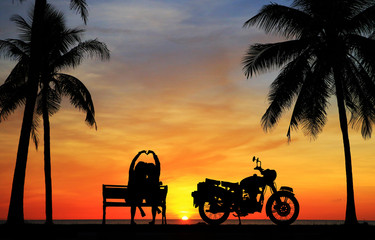 Wall Mural - silhouette of lover couple in sunset with classic motorcycle