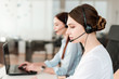© Anastasia - Friendly young female technical support dispatcher with a headset working in a call center on a hotline, talking on the phone. Portrait of an attractive customer care representative. Business concept