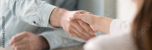 Cuadros en Lienzo Close up panoramic image businesswoman and businessman shaking hands